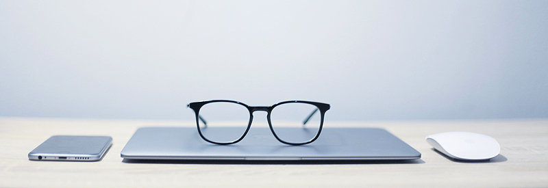 Eye glasses sitting on a computer